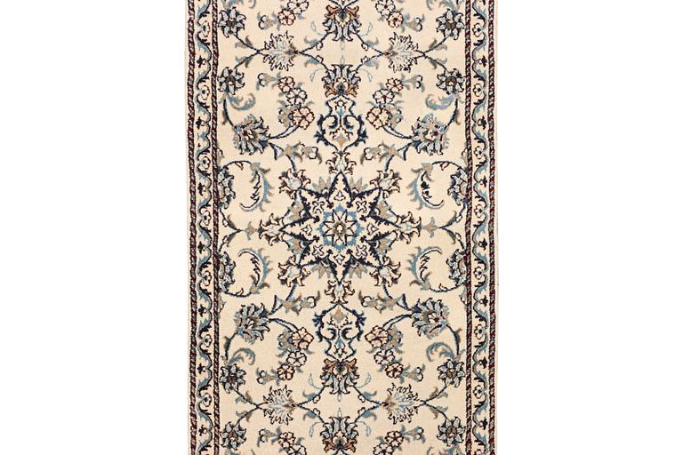 A Nain runner carpet, part silk, c. 298 x 80 cm.