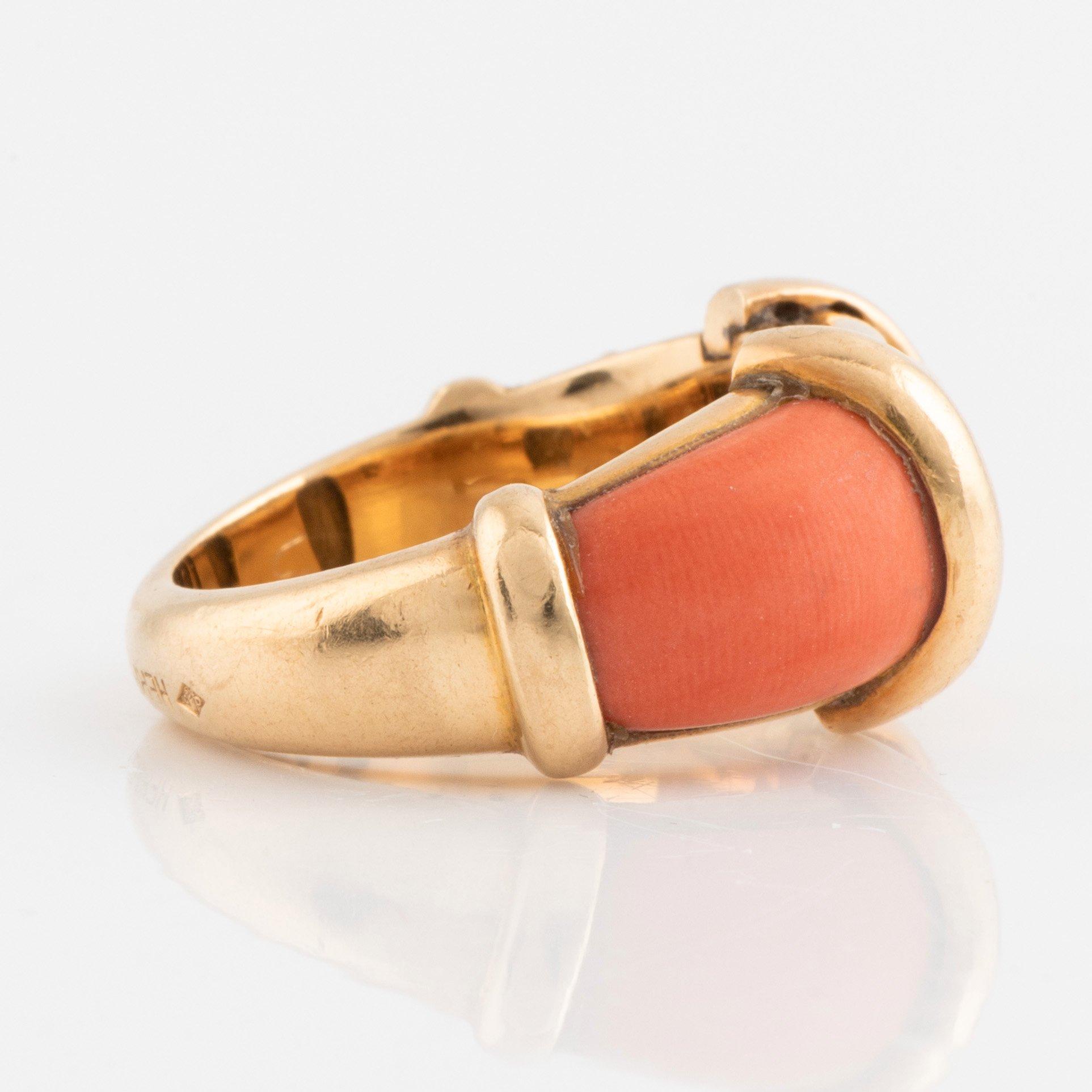 An 18K gold and coral Hermès ring.