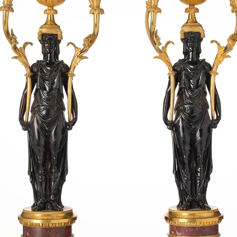 A pair of Louis XVI ormolu and patinated bronze six-branch candelabra attributed to François Rémond, late 18th century.