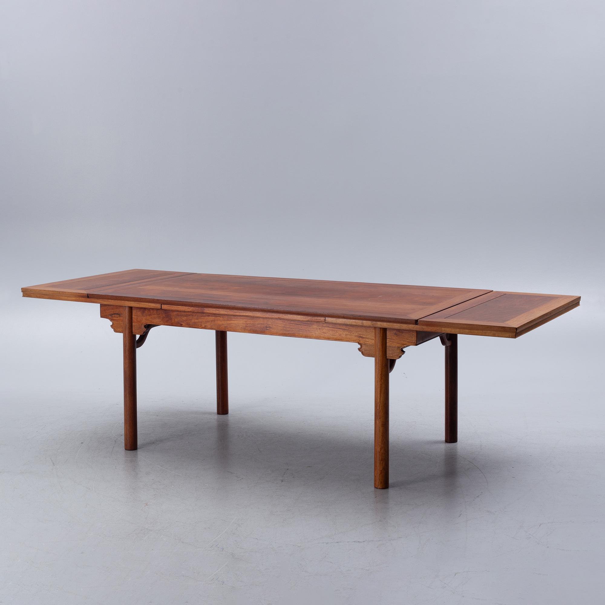 A Chinese hardwood dinner table and ten chairs with rattan seats, 20th century.