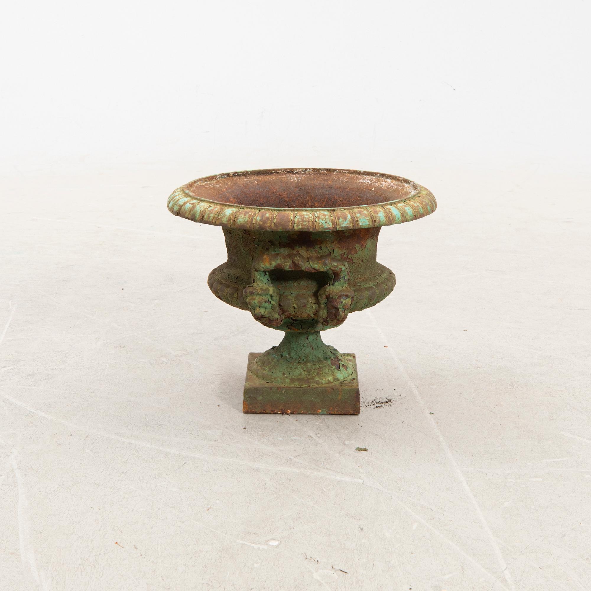 A cast iron garden urn around 1900.