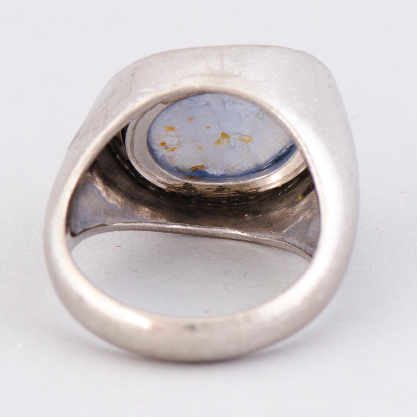 A RING, cabochon cut star sapphire, 8/8 cut diamonds, 18K white gold. A. Tillander, Helsinki Finland 1974.