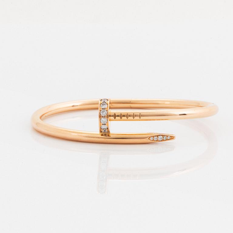 A Cartier "Juste en Clou" bracelet in 18K rose gold set with round brilliant-cut diamonds.