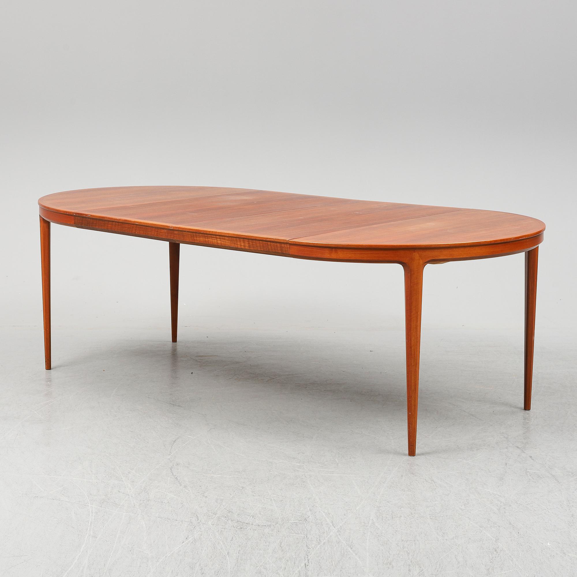 BERTIL FRIDHAGEN, a seven  piece walnut dining suite from Bodafors.