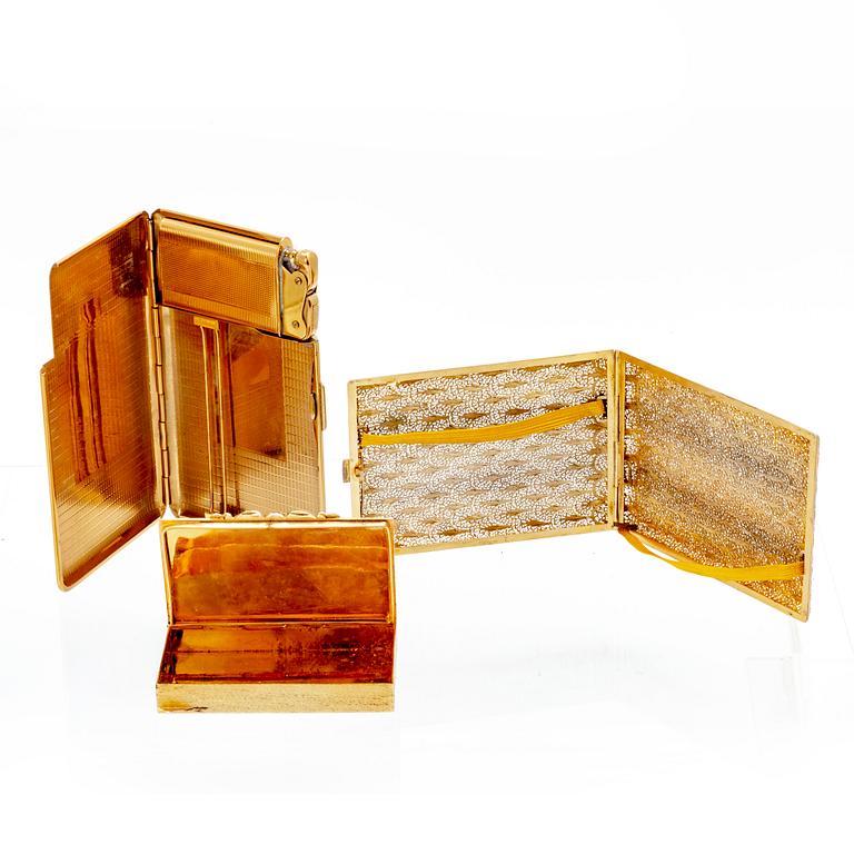 A set of three 20th century gold metal cigaret cases.