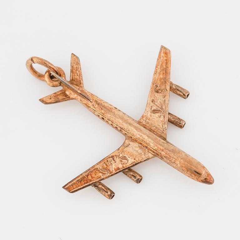 A 14K gold pendant in the form of a plane.