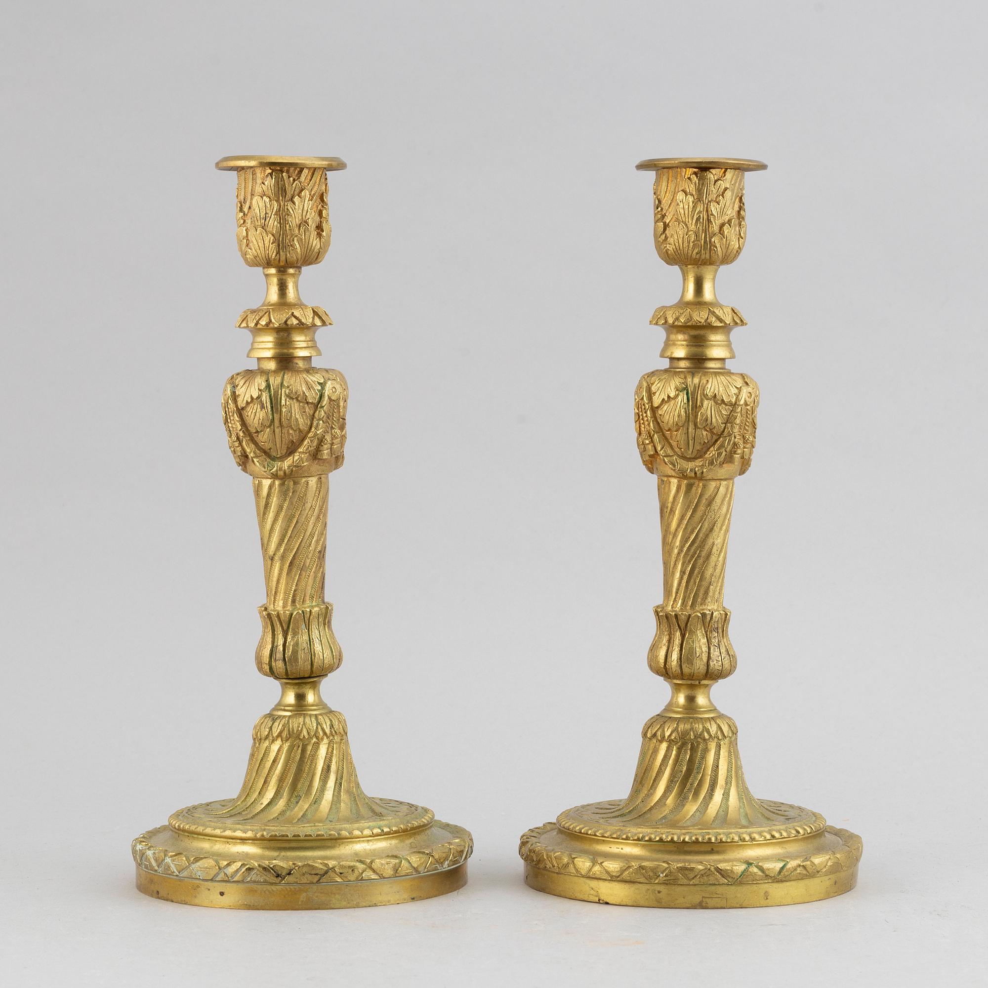 A pair of bronze Louis XV-style candlesticks, circa 1900.