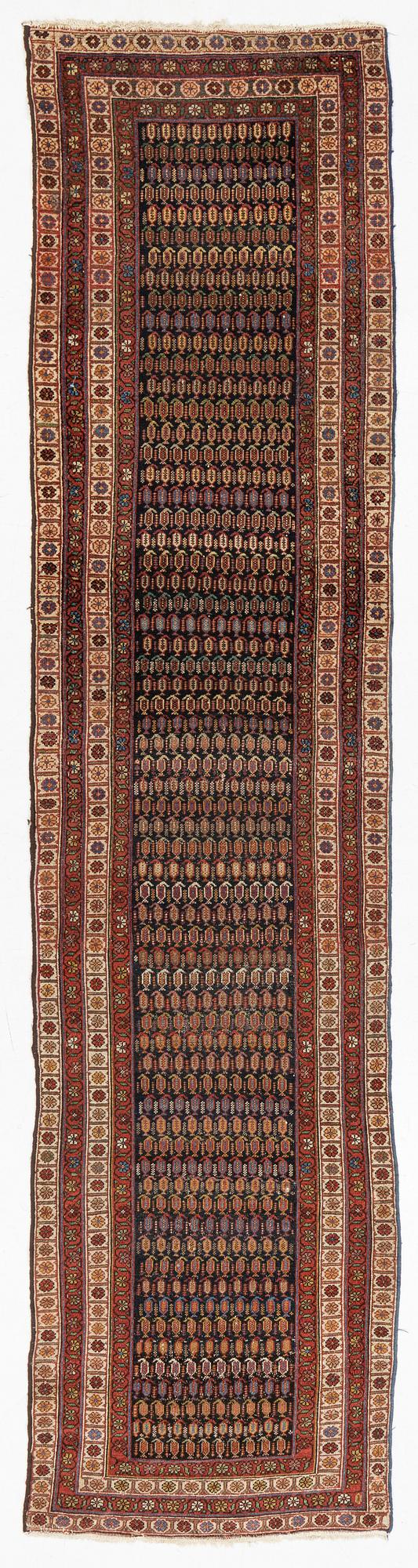 An antique runner carpet, approx. 400 x 93 cm.