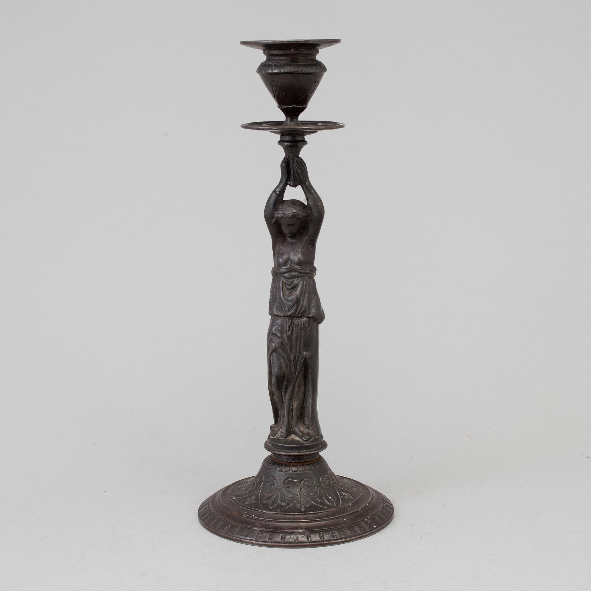 A 19th century iron candlestick marked F.L Vombach Offenbach A/M.