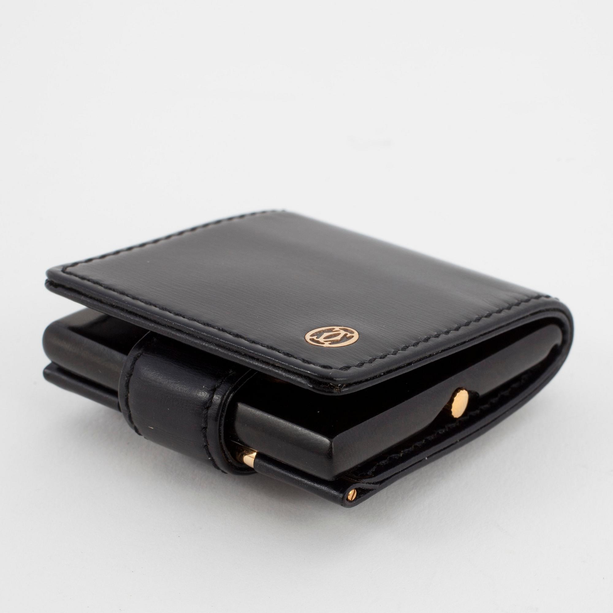 CARTIER, a travelwatch in a black leather case.