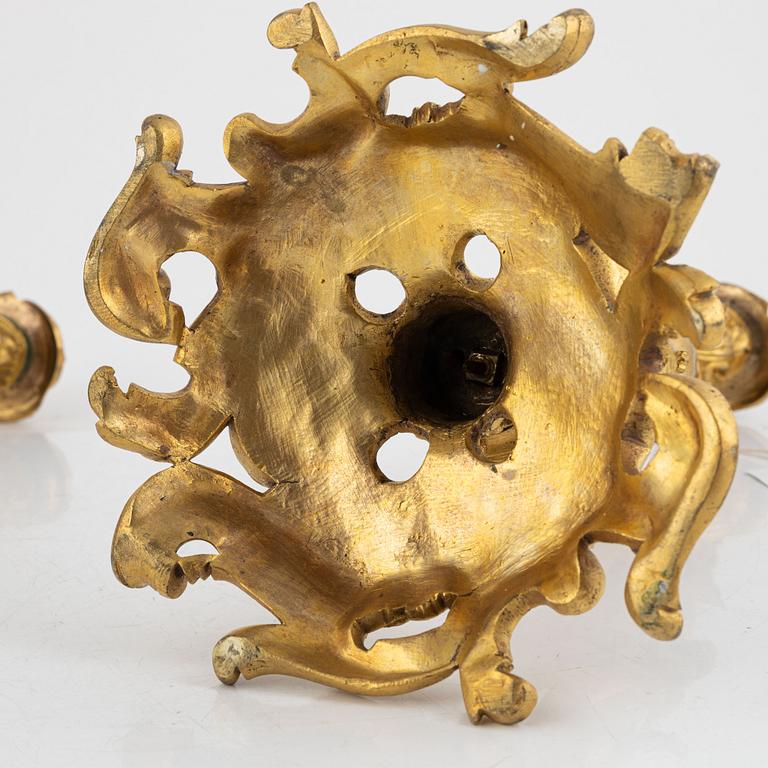 A pair of French gilt-bronze Louis XV-style candlesticks, late 19th century.