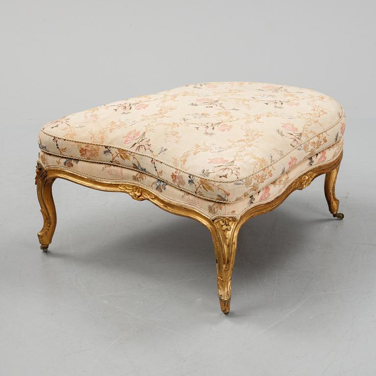 A Louis XV-style bergère armchair with stool, second half of the 19th century.