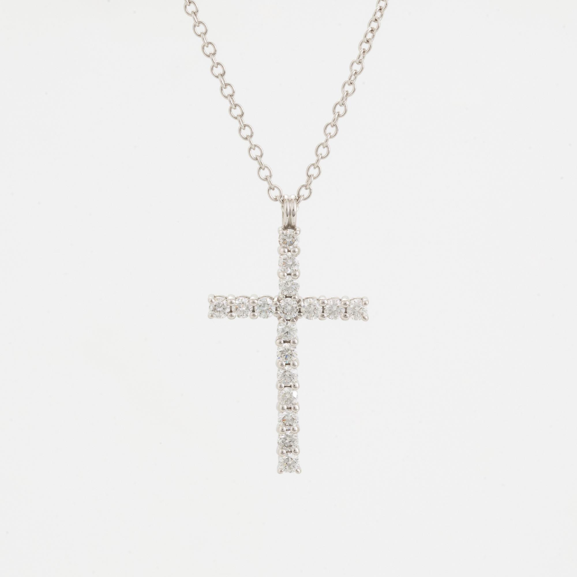 Brilliant-cut diamond cross pendant.