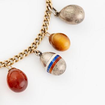 Bracelet with charms in the shape of eggs, the bracelet is 14K gold and 13 loose charms in the shape of eggs.