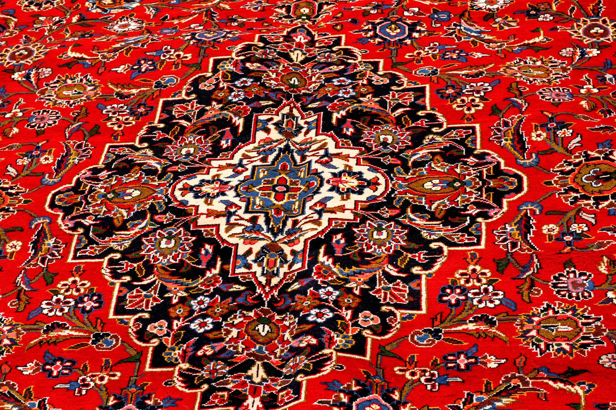 A Keshan rug, signed, 410 x 295 cm.