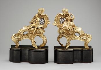 A pair of Louis XV 18th Century bronze chenets, in the manner of Caffieri.