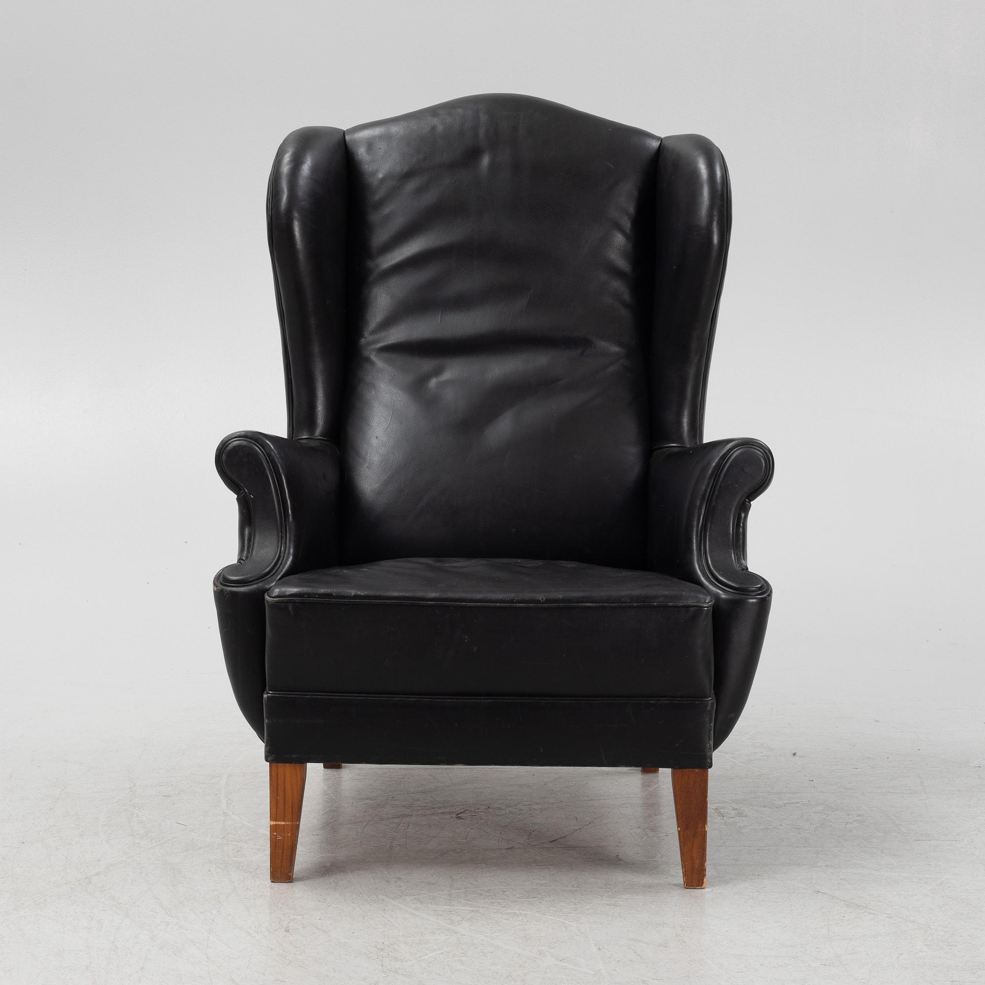 A leather upholstered wingback chair, 20th Century.