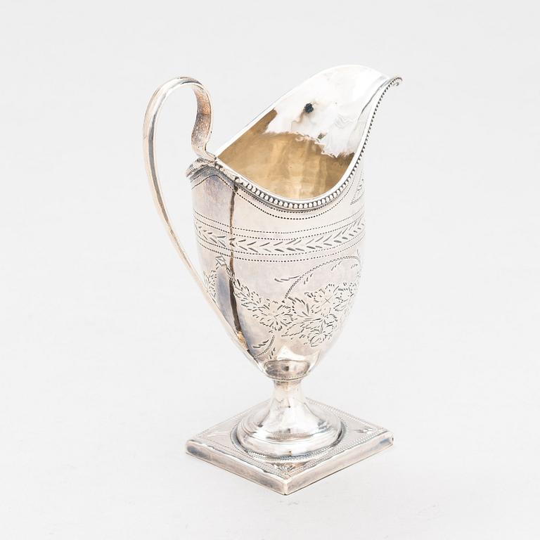 A sterling silver cream jug from London 1796, and a sterling spoon with maker's mark of Thomas Wallis II, London 1805.