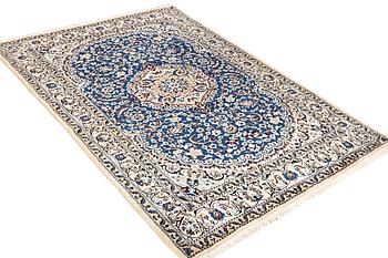 A Nain carpet, part silk, 9 laa, c. 300 x 189 cm.