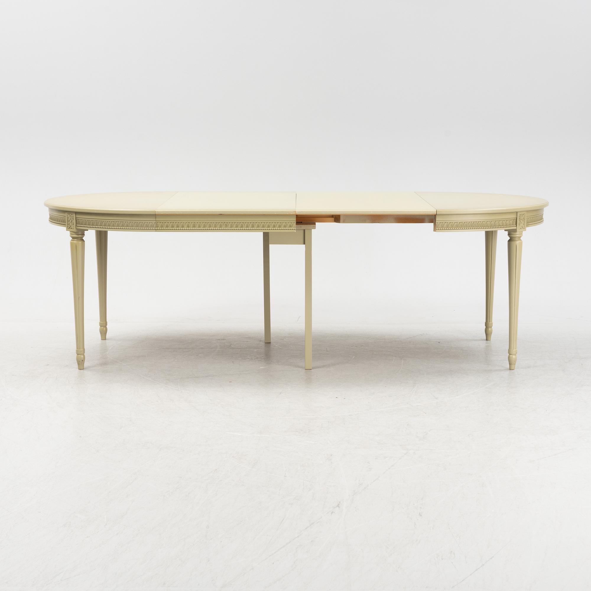 A Gustavian dining table with six chairs. Åmells dated 1974.