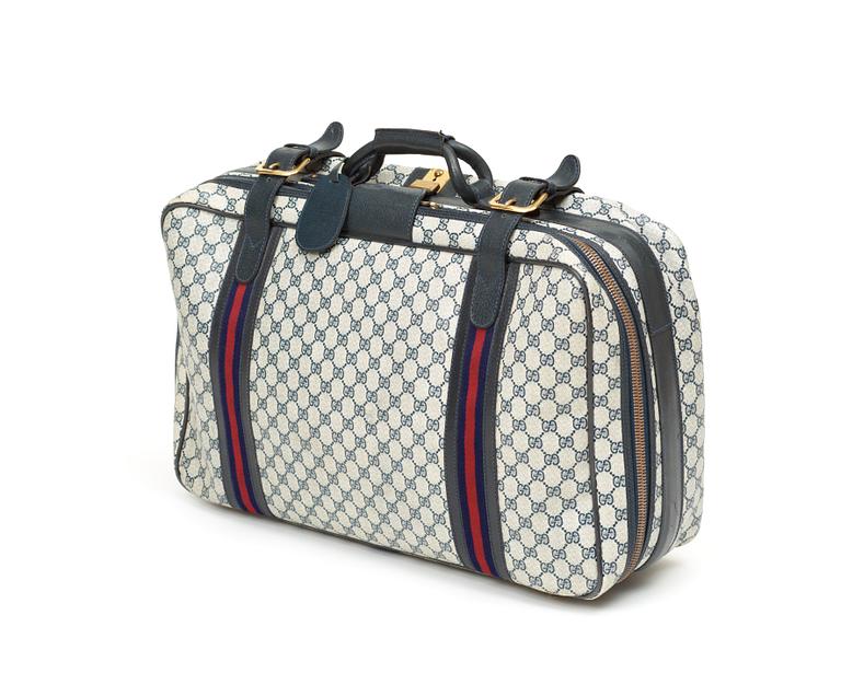 A travelling bag by Gucci.