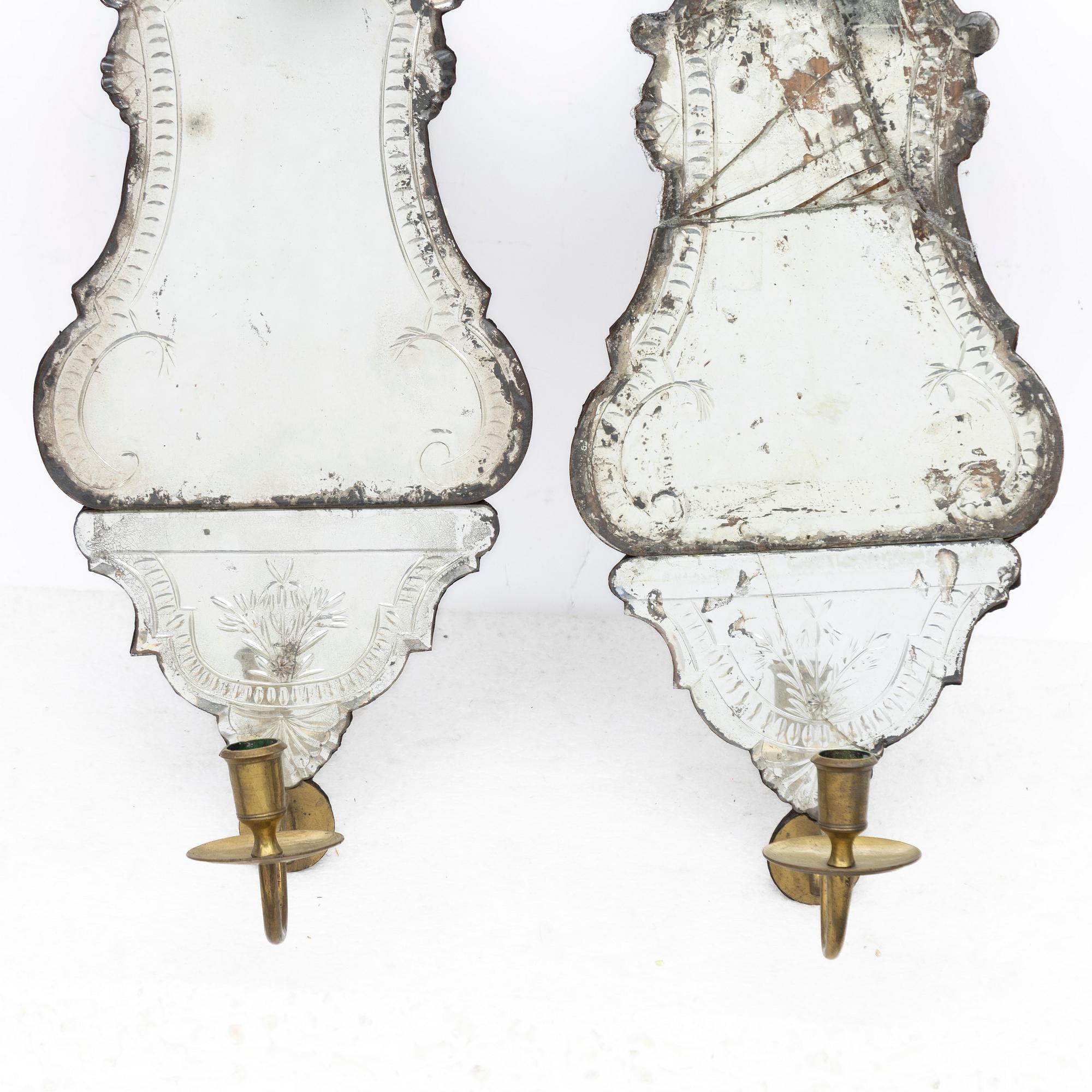 A pair of Nort European late baroque one-light girandole mirrors, mid 18th century.