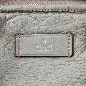 Gucci, a leather bag.