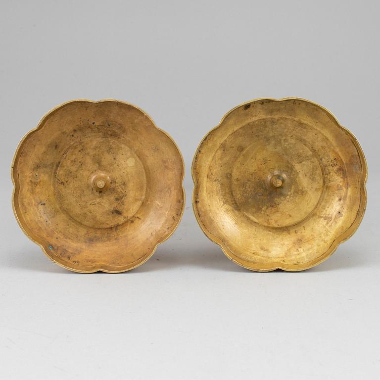 A pair of ormolu late empire candlesticks, mid 19th century.