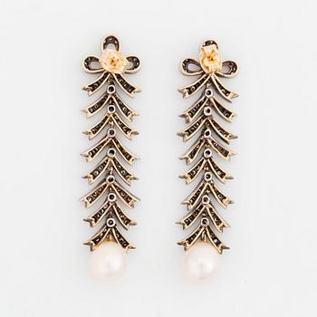 A pair of silver and 18K gold earrings with cultured pearls and set with eight-cut diamonds.