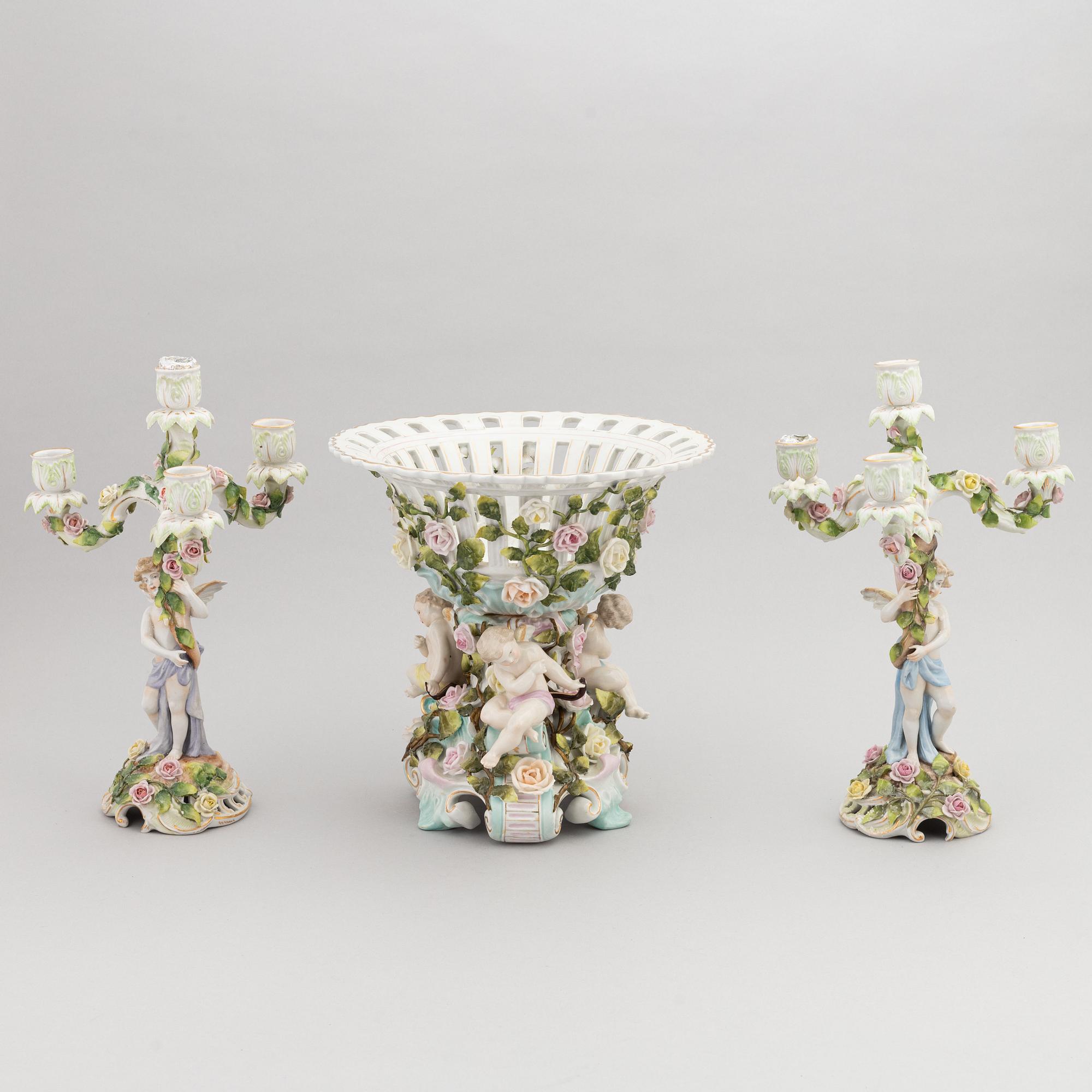 A pair of porcelain rococo style candelabra and a centerpiece bowl, Plaue, Germany, first half of the 20th century.