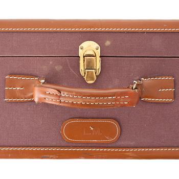 T ANTHONY Ltd, a aubergine canvas suitcase from the 1970s.