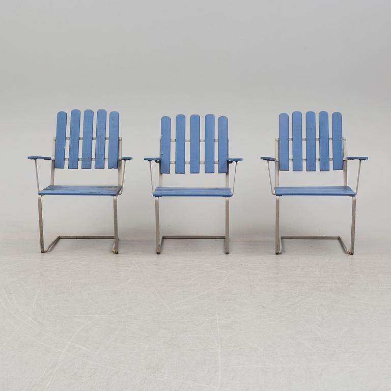 A painted garden table and four armchairs, first half of the 20th century.