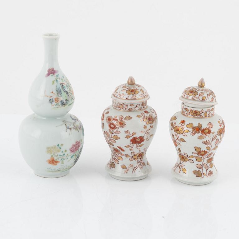 A pair of Kangxi urns, China, early 18th century, and a gourd-shaped vase, China, late 19th century.
