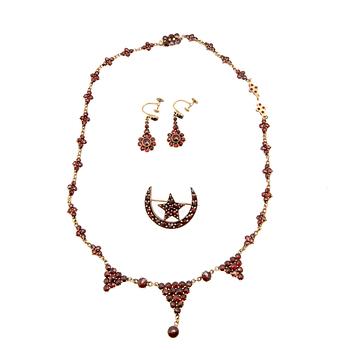 Necklace, earrings, and brooch with faceted garnets.