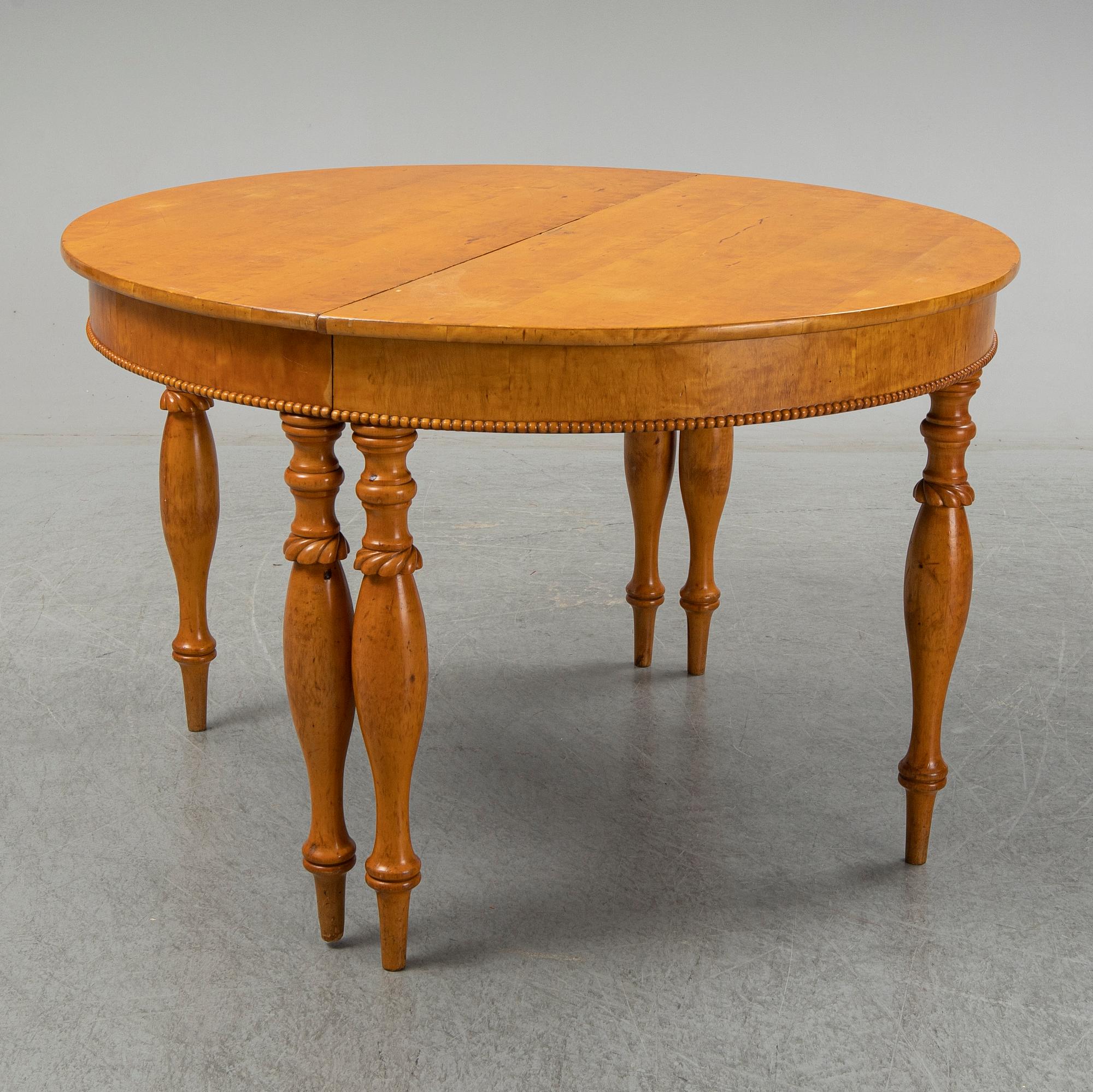 A mid 19th century birch dining table.