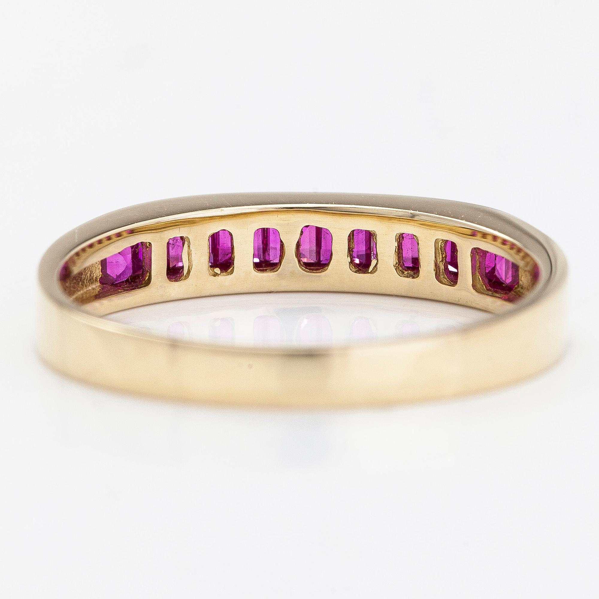 A 14K half eternity gold ring, with rubies.