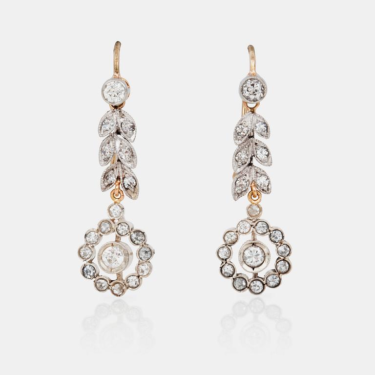 A pair of flower shaped old-cut diamond earrings.