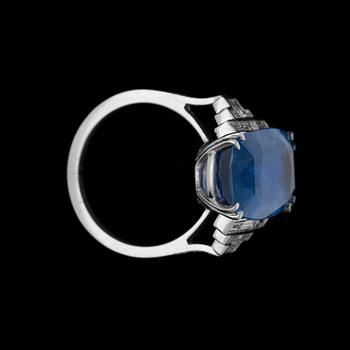 An untreated sapphire ring, 15.80 cts, set with step cut diamonds.