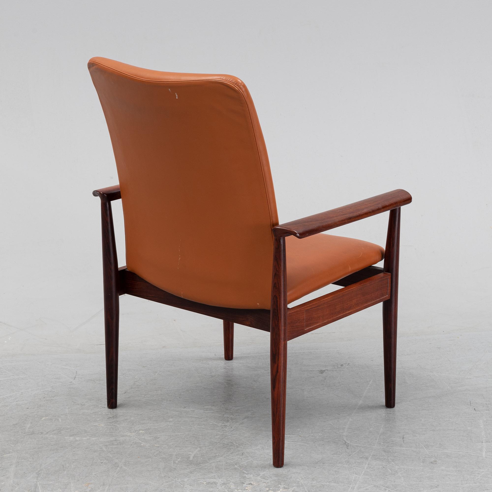 Finn Juhl, a rosewood easy chair, from Cado, Denmark, 1960's/70's.