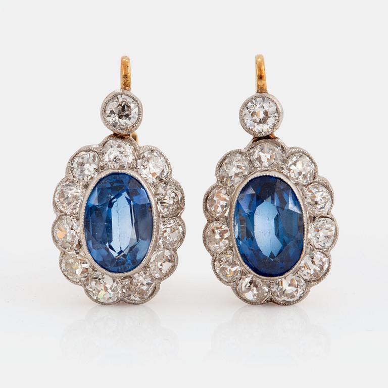 A pair of 14K gold and platinum earings set with faceted synthetic sapphires and old-cut diamonds.