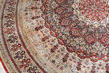 An Oriental silk rug, diameter 256 cm.