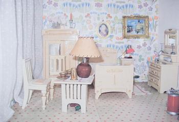 A doll house with interior and dolls ca 1910.