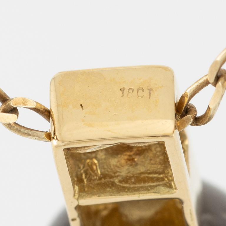 Pendant in 18K gold with a cultured pearl and faceted white stones.