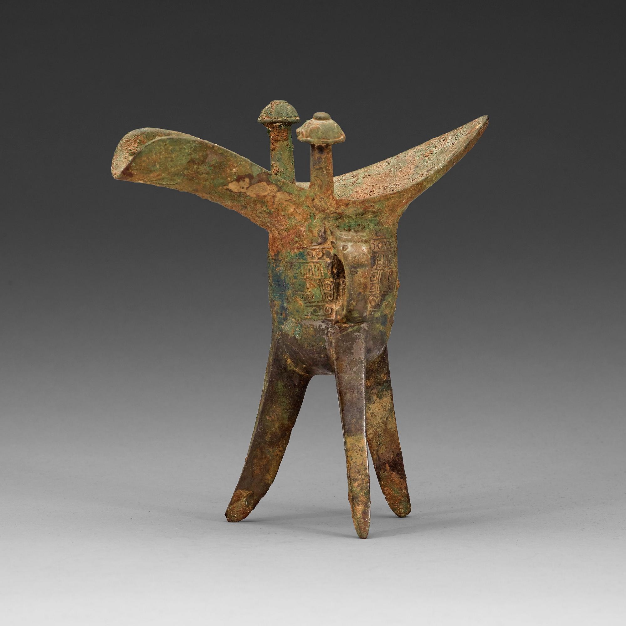 A bronze ritural tripod wine vessel 'Jue', presumably Shang dynasty, 12/11th Century BC.