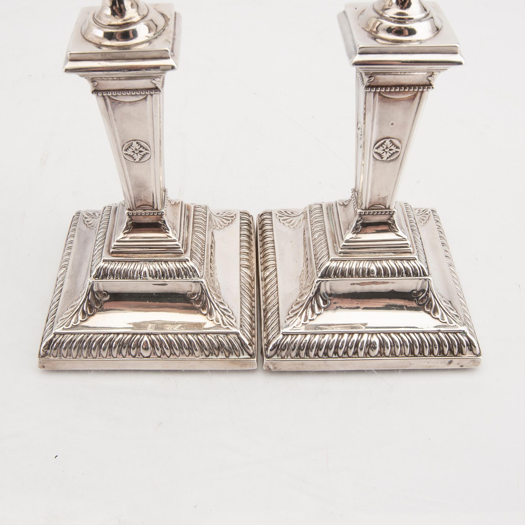 An English 20th century pair of silver candle sticks mark of Mappin & Webb London around 1900.