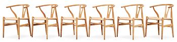 59. A set of six Hans J Wegner oak 'Wishbone chairs', Carl Hansen & Søn, Denmark.