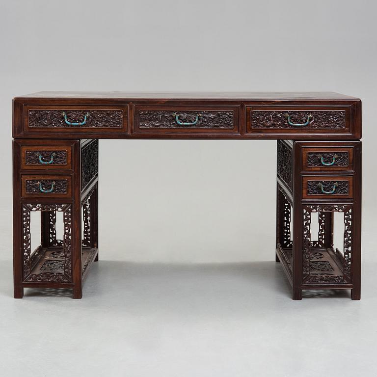 A carved hardwood desk, late Qing dynasty, circa 1900.