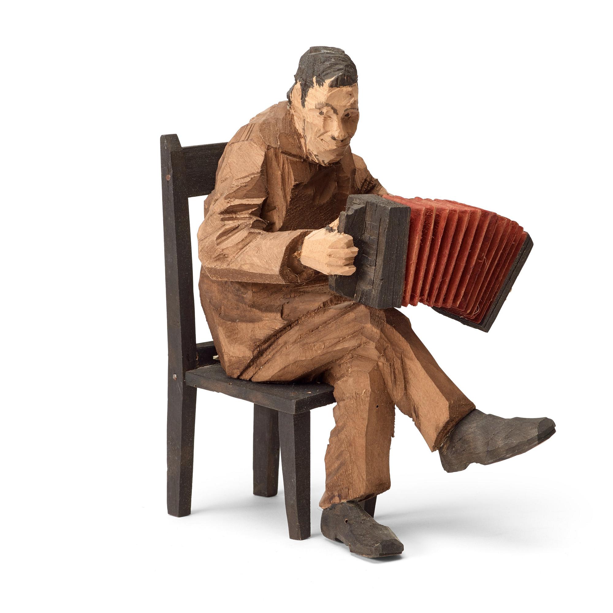 Axel Petersson Döderhultarn, Seated accordionist.