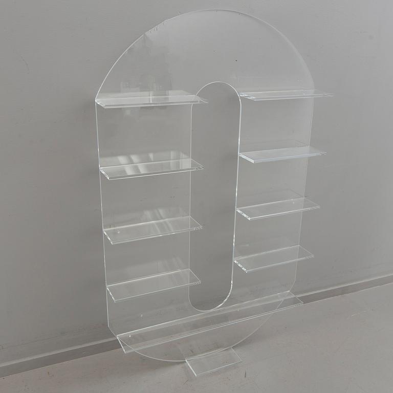 Shelf, plexi glass, in the shape of the letter 'O',Non Violence.