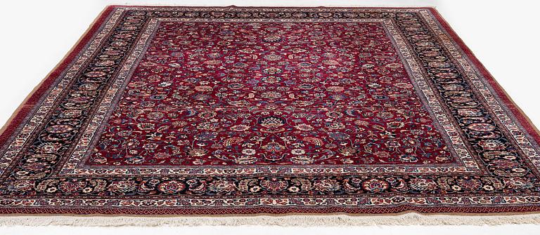 A Mashad carpet, signed Saber, c. 402 x 299 cm.